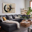 Cuadro decorativo abstracto con círculo negro y líneas geométricas en tonos beige, gris y naranja
